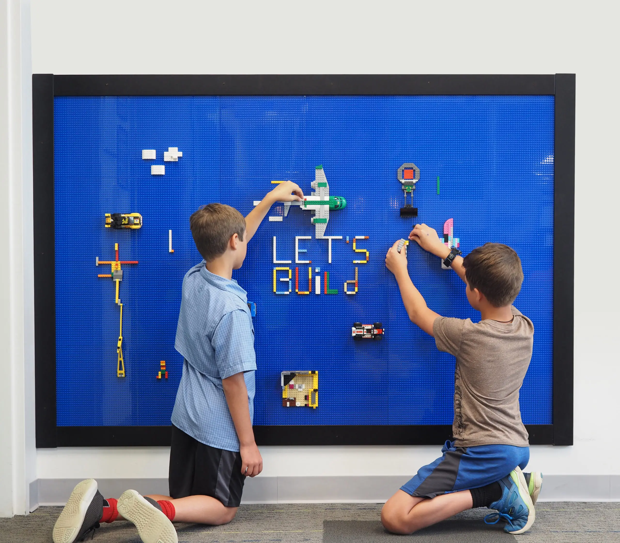 Boys building with blocks on a Slab Dream Lab slab in a Slab Dream Lab frame