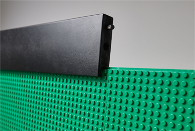 Closeup of a black mounting frame with a green slab baseplate